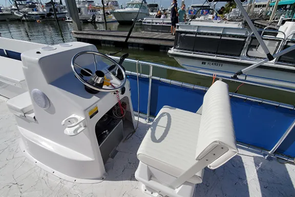 a blue and white boat parked at a dock