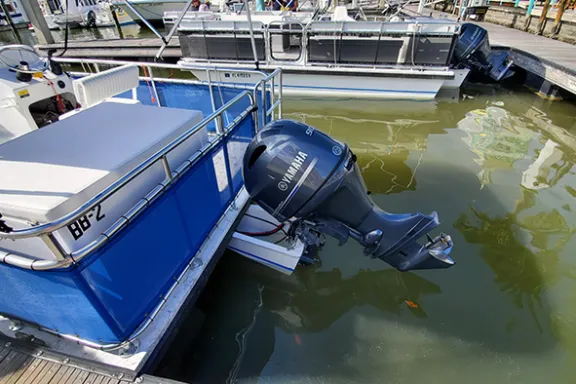 a boat is docked next to a body of water