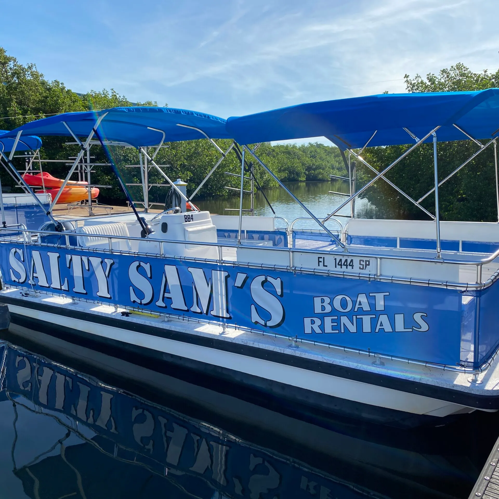 a blue and white boat parked at a dock