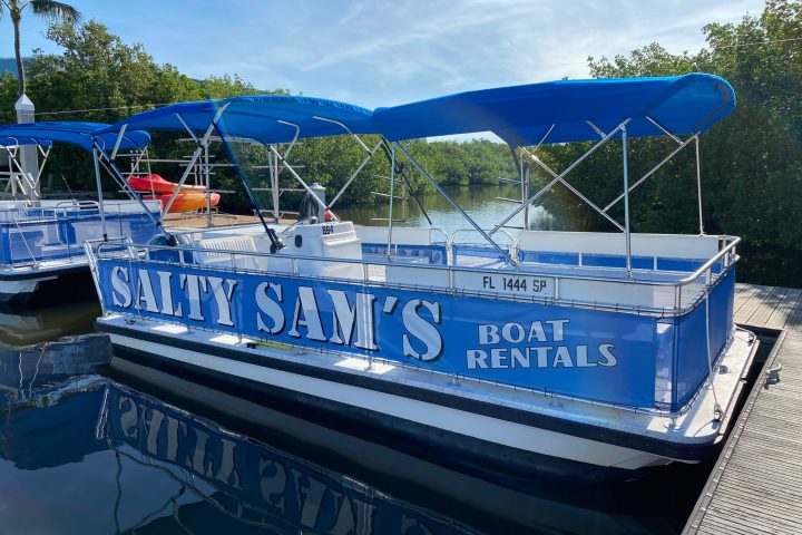 a blue and white boat parked at a dock