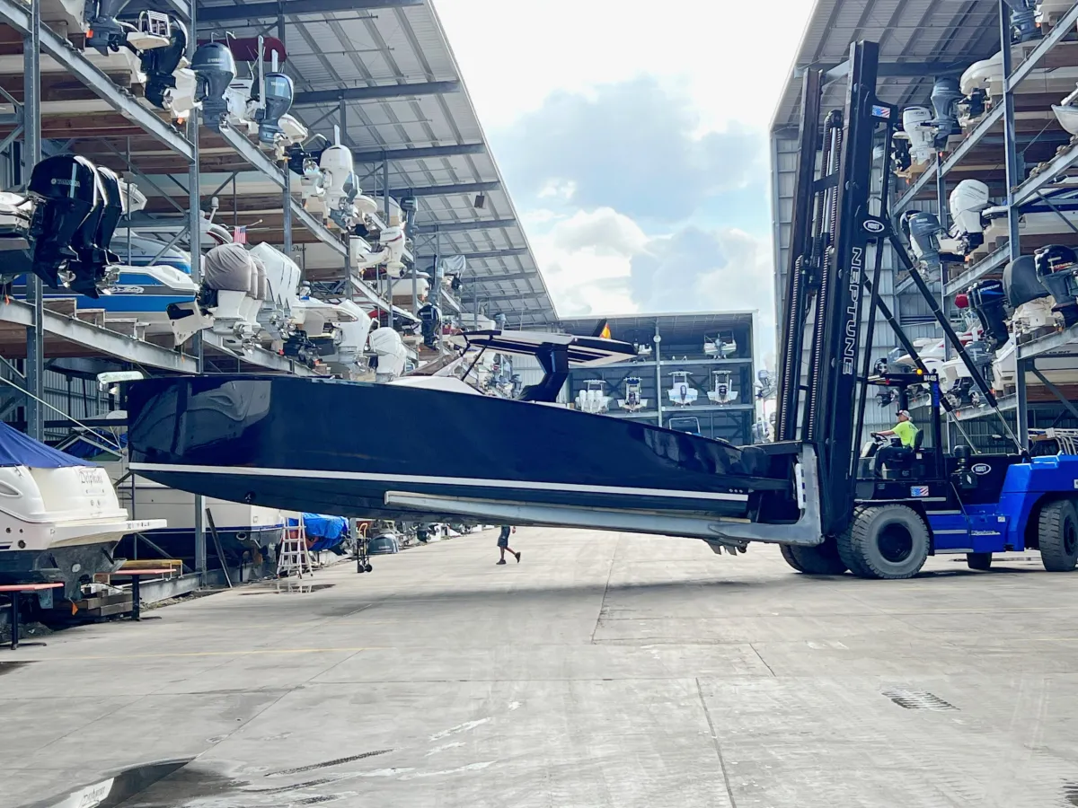 a large jetliner sitting on top of a blue truck