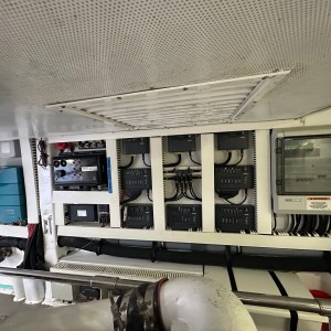 Marine engine room with electrical panels and control equipment.